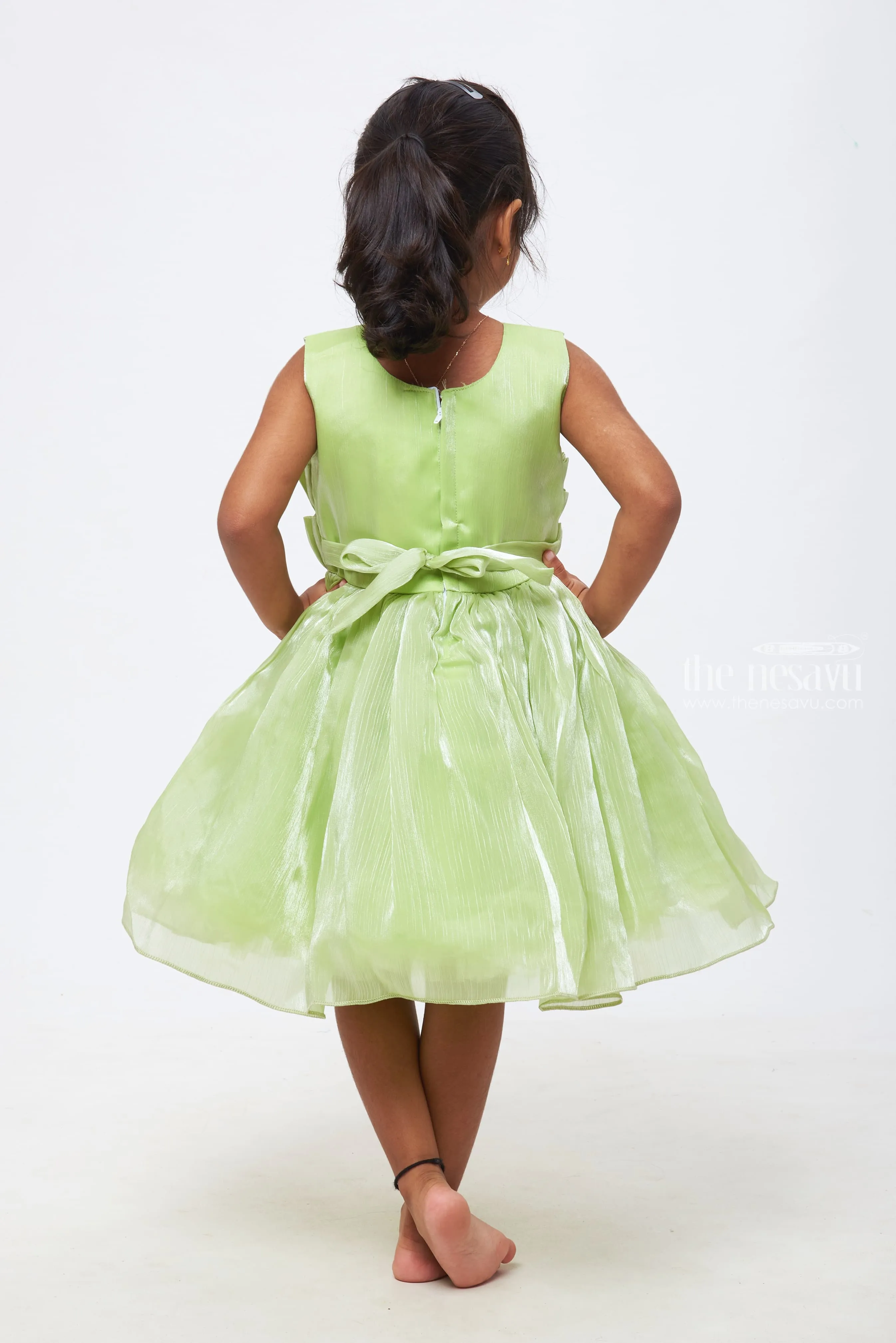 Emerald Enchantment: Girls Soft Green Tulle Dress with Rosette Accents