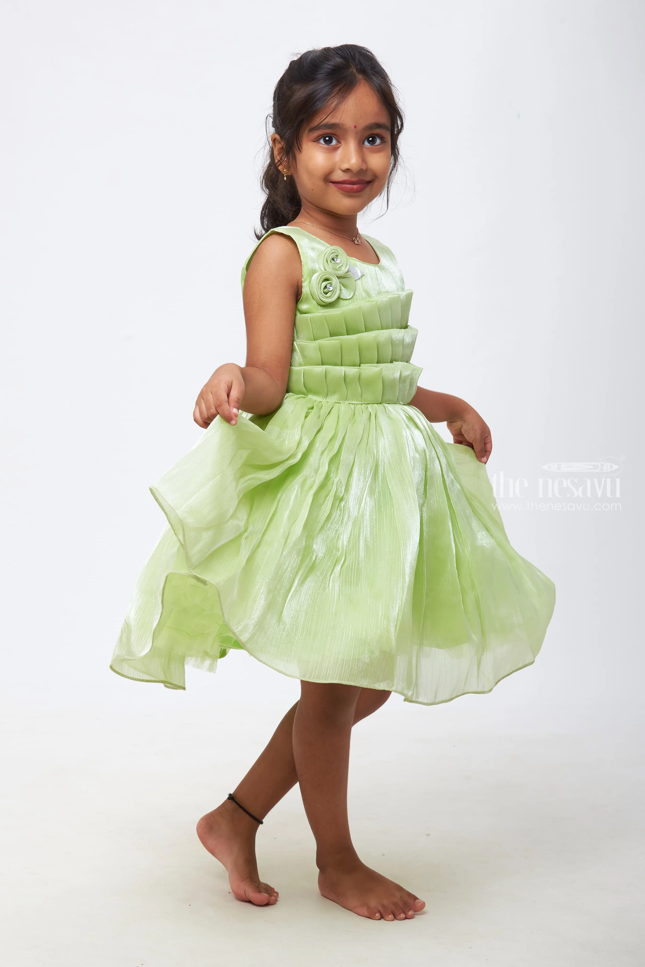 Emerald Enchantment: Girls Soft Green Tulle Dress with Rosette Accents